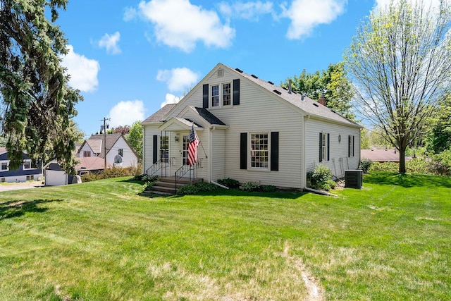 view of front of home with central AC unit and a front lawn