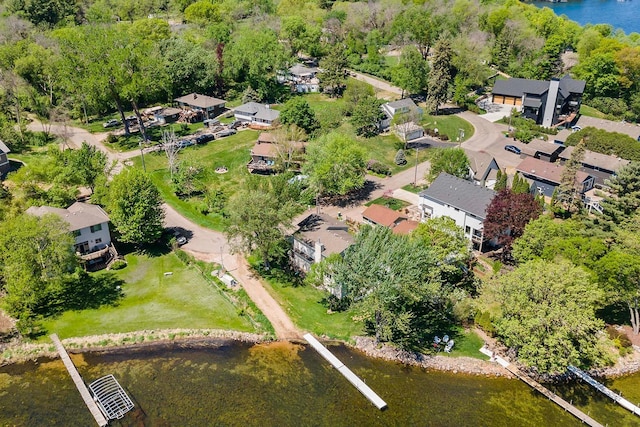 aerial view of property and surrounding area with nearby suburban area and a large body of water