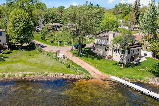 aerial view of property and surrounding area featuring a large body of water