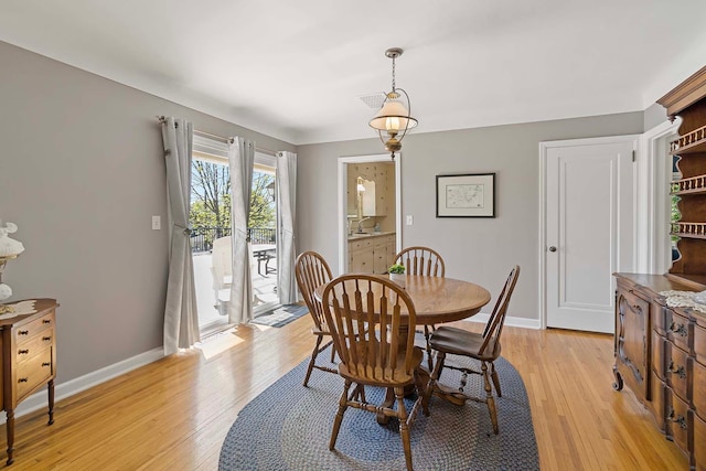 dining room with light wood finished floors and baseboards