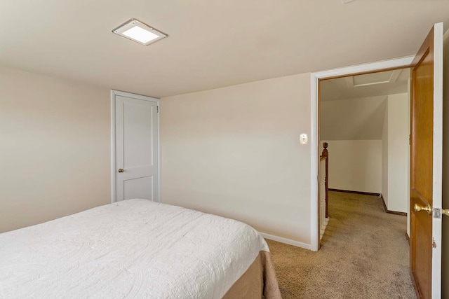 bedroom with light carpet and baseboards