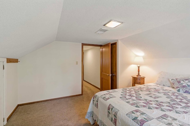 bedroom with a textured ceiling, lofted ceiling, carpet floors, and baseboards