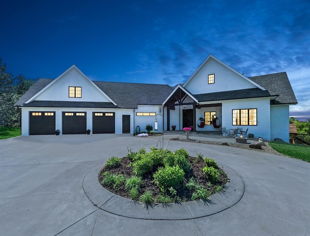 2169 Ibson Ave SE, Rockford Twp, MN 55313 - modern inspired farmhouse with an attached garage, curved driveway, stucco siding, and a shingled roof