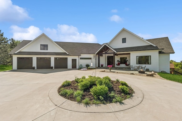 2169 Ibson Ave SE, Rockford Twp, MN 55313 - modern farmhouse style home with curved driveway, an attached garage, stucco siding, and roof with shingles