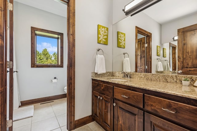 2169 Ibson Ave SE, Rockford Twp, MN 55313 - bathroom featuring vanity, toilet, baseboards, and tile patterned floors