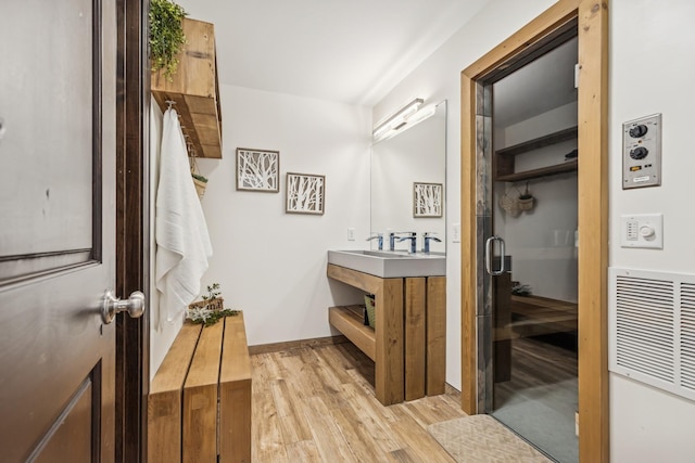2169 Ibson Ave SE, Rockford Twp, MN 55313 - bathroom featuring wood finished floors, vanity, and baseboards