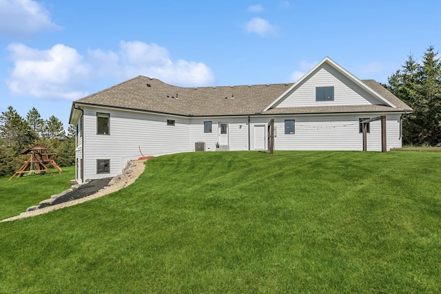 2169 Ibson Ave SE, Rockford Twp, MN 55313 - rear view of property featuring a lawn, roof with shingles, central AC, and a playground