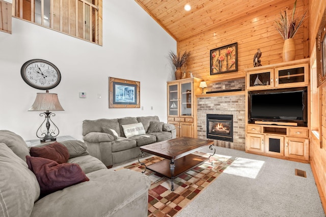 21140 654th Ave, Litchfield, MN 55355 - living area featuring high vaulted ceiling, wood ceiling, wood walls, carpet, and a brick fireplace