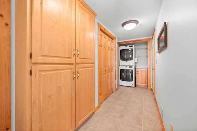 21140 654th Ave, Litchfield, MN 55355 - hall with stacked washer / dryer, light tile patterned floors, and a textured ceiling