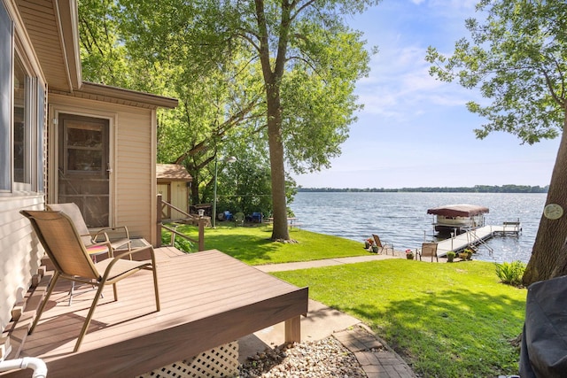 21140 654th Ave, Litchfield, MN 55355 - wooden terrace featuring a water view, a lawn, a dock, and boat lift