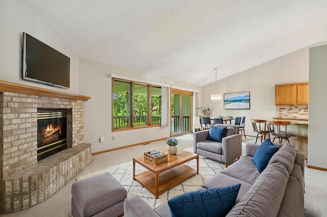 2558 75th St E, Inver Grove Heights, MN 55076 - living area featuring a chandelier, light colored carpet, vaulted ceiling, and a fireplace