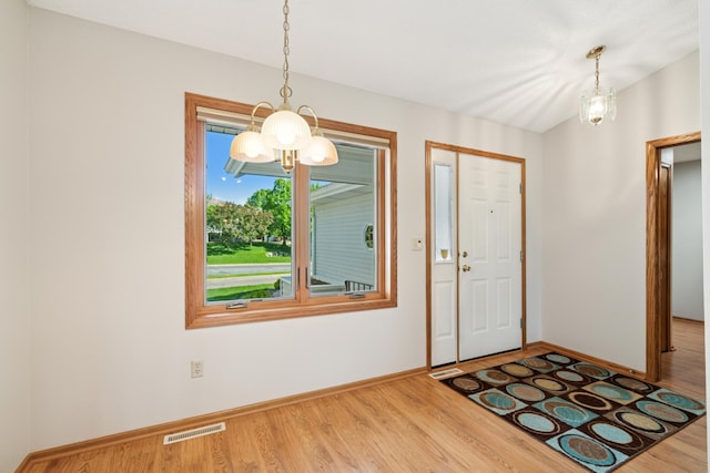 2558 75th St E, Inver Grove Heights, MN 55076 - foyer entrance with a chandelier and wood finished floors