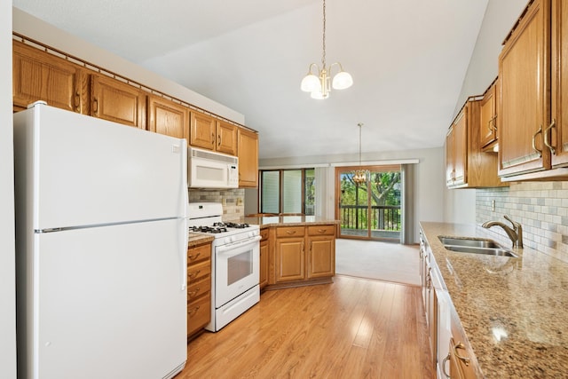 2558 75th St E, Inver Grove Heights, MN 55076 - kitchen with white appliances, a chandelier, light wood finished floors, vaulted ceiling, and tasteful backsplash