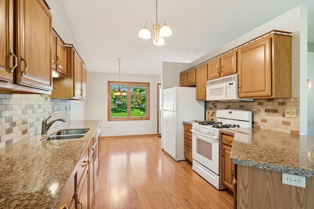2558 75th St E, Inver Grove Heights, MN 55076 - kitchen with white appliances, a chandelier, light wood-type flooring, and brown cabinetry