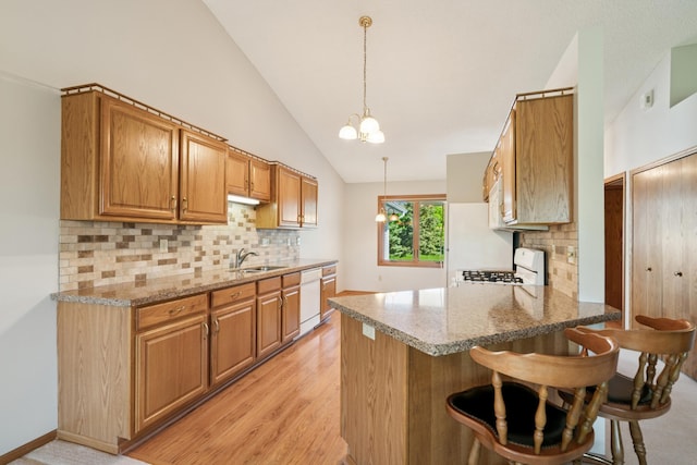 2558 75th St E, Inver Grove Heights, MN 55076 - kitchen featuring dishwasher, a peninsula, backsplash, stove, and high vaulted ceiling