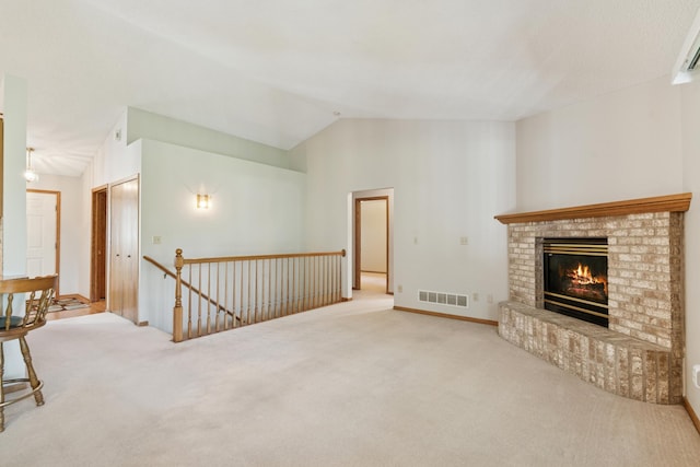 2558 75th St E, Inver Grove Heights, MN 55076 - unfurnished living room with carpet flooring, lofted ceiling, and a fireplace