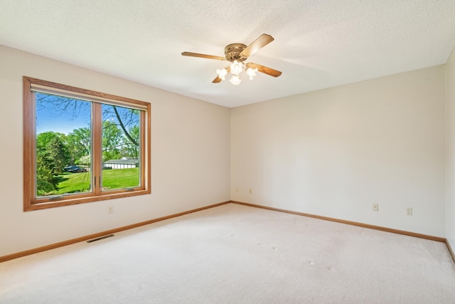 2558 75th St E, Inver Grove Heights, MN 55076 - spare room with light carpet, a ceiling fan, and a textured ceiling