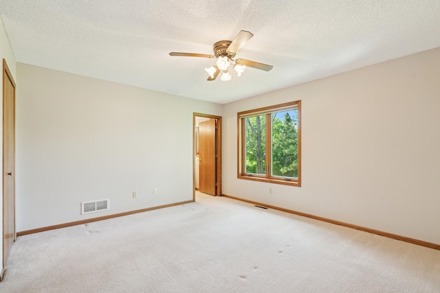 2558 75th St E, Inver Grove Heights, MN 55076 - spare room featuring light colored carpet, a ceiling fan, and a textured ceiling