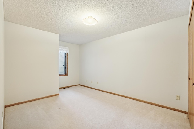2558 75th St E, Inver Grove Heights, MN 55076 - unfurnished room with light colored carpet and a textured ceiling