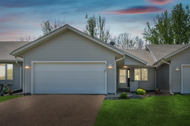 2558 75th St E, Inver Grove Heights, MN 55076 - view of front of property featuring an attached garage, asphalt driveway, a shingled roof, and a lawn