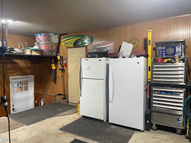 407 2nd Ave W, Lisbon, ND 58054 - garage with wood walls and freestanding refrigerator