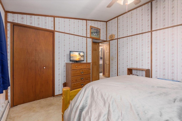 1361 60th St Unit D, Apple River Twp, WI 54889 - carpeted bedroom featuring a baseboard heating unit, wallpapered walls, a closet, ornamental molding, and ceiling fan