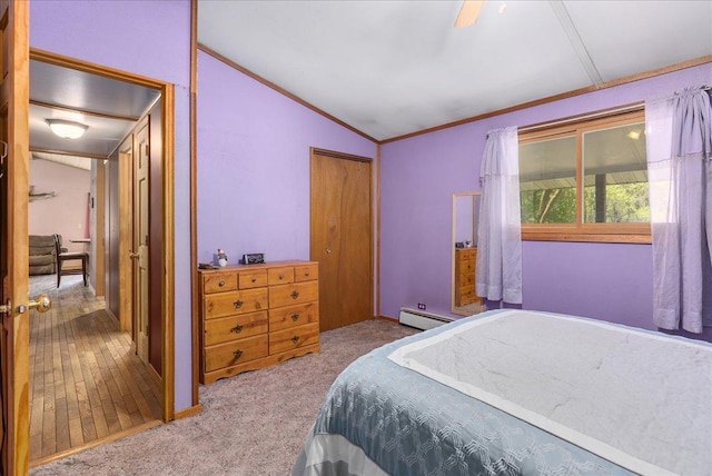 1361 60th St Unit D, Apple River Twp, WI 54889 - bedroom featuring a baseboard heating unit, vaulted ceiling, a closet, ornamental molding, and carpet floors
