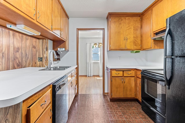7109 Penn Ave S, Richfield, MN 55423 - kitchen featuring black appliances, a sink, light countertops, and under cabinet range hood