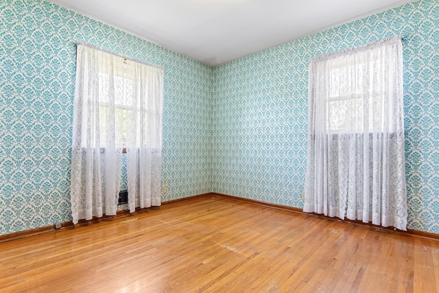 7109 Penn Ave S, Richfield, MN 55423 - spare room with hardwood / wood-style floors, plenty of natural light, wallpapered walls, and baseboards