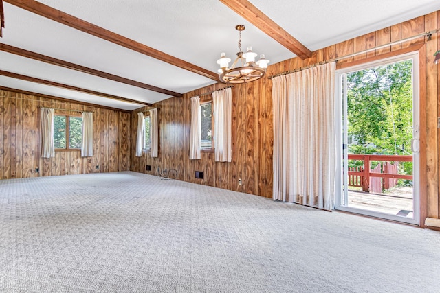 7109 Penn Ave S, Richfield, MN 55423 - empty room featuring beam ceiling, a chandelier, carpet floors, and wooden walls