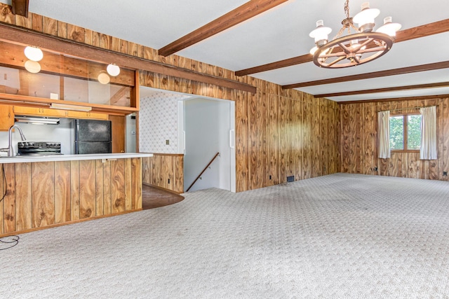 7109 Penn Ave S, Richfield, MN 55423 - unfurnished living room featuring beam ceiling, carpet, a chandelier, and wood walls