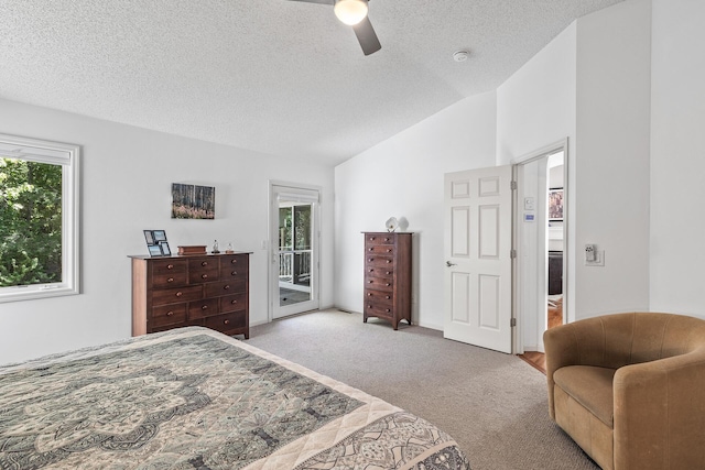 carpeted bedroom with access to outside, lofted ceiling, a textured ceiling, and a ceiling fan