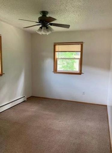 7673 River Rd, Fridley, MN 55432 - carpeted spare room featuring a ceiling fan, baseboard heating, and a textured ceiling