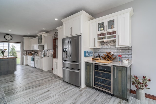 37854 210th Ave SE, Knute Twp, MN 56535 - kitchen with stainless steel fridge, wine cooler, backsplash, light wood-style flooring, and recessed lighting