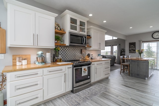 37854 210th Ave SE, Knute Twp, MN 56535 - kitchen with appliances with stainless steel finishes, open shelves, butcher block counters, tasteful backsplash, and recessed lighting