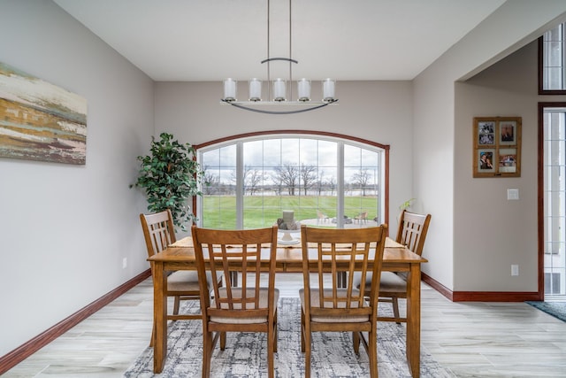 37854 210th Ave SE, Knute Twp, MN 56535 - dining space with light wood finished floors, baseboards, and a chandelier
