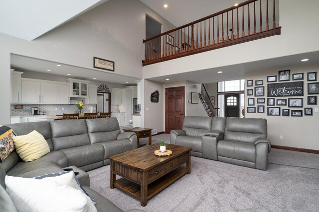 37854 210th Ave SE, Knute Twp, MN 56535 - living room featuring stairs, baseboards, carpet, recessed lighting, and high vaulted ceiling