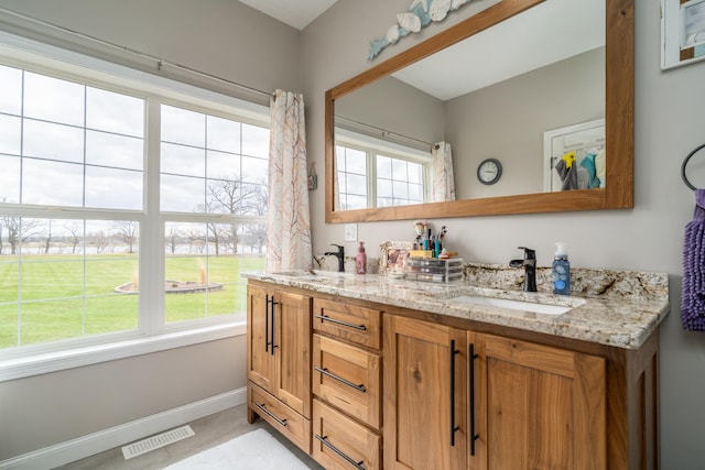 37854 210th Ave SE, Knute Twp, MN 56535 - bathroom with double vanity and baseboards