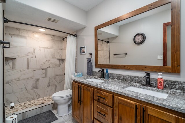 37854 210th Ave SE, Knute Twp, MN 56535 - bathroom featuring a tile shower, toilet, double vanity, and marble finish flooring
