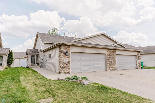 view of front of home featuring driveway, a garage, stone siding, roof with shingles, and a gate