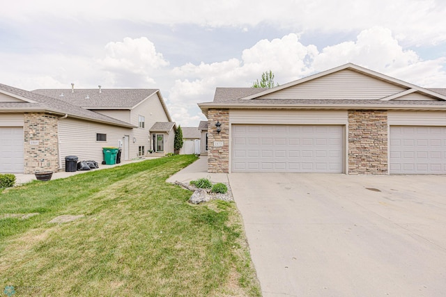 view of home's exterior featuring a yard, concrete driveway, stone siding, and an attached garage