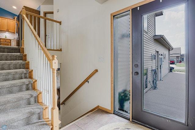 foyer entrance featuring stairs, light tile patterned floors, baseboards, and recessed lighting