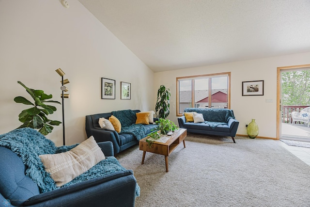 carpeted living room with baseboards and high vaulted ceiling