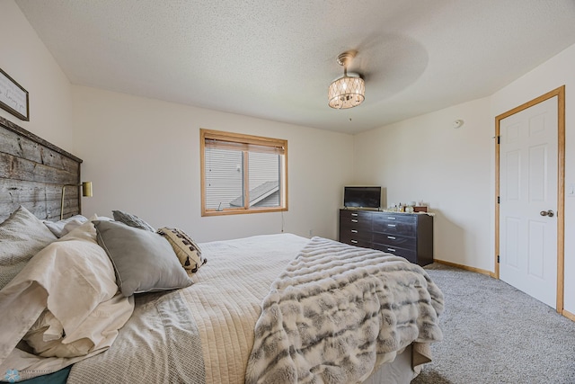 bedroom with carpet floors and baseboards