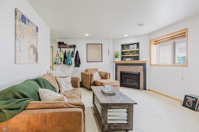 living area with carpet flooring, a tile fireplace, baseboards, and recessed lighting