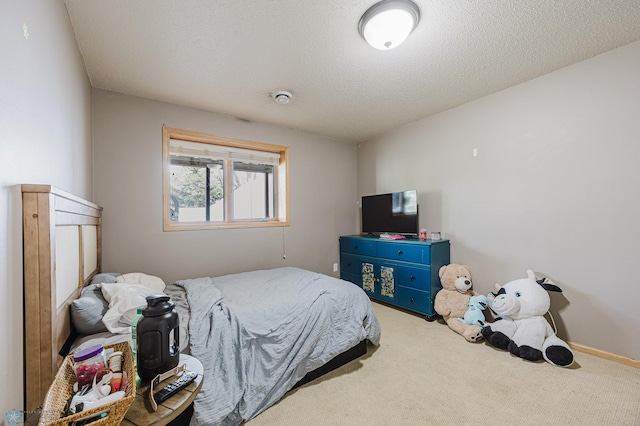 carpeted bedroom featuring a textured ceiling