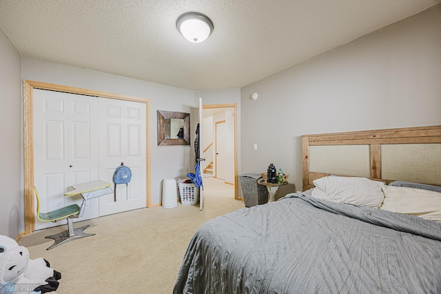 carpeted bedroom featuring a closet and a textured ceiling