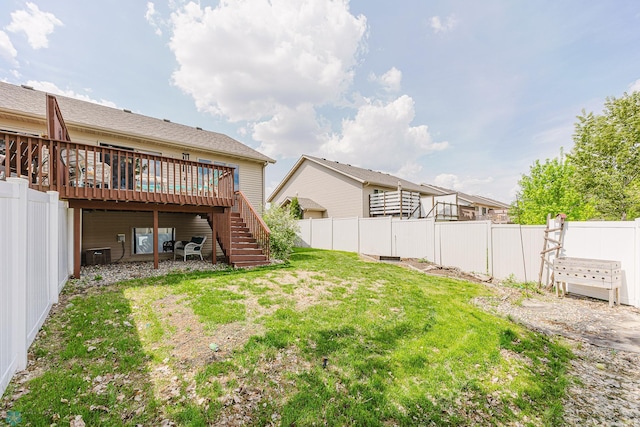 view of yard with stairway, a wooden deck, and central AC