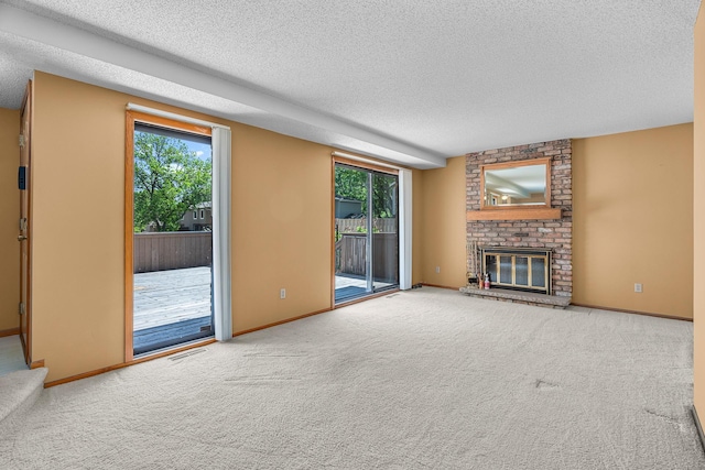 2111 Tamarin Trl, Golden Valley, MN 55427 - unfurnished living room with a textured ceiling, plenty of natural light, a fireplace, and carpet flooring