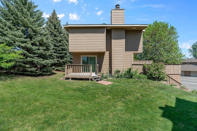2111 Tamarin Trl, Golden Valley, MN 55427 - back of house featuring a deck, a chimney, and a yard